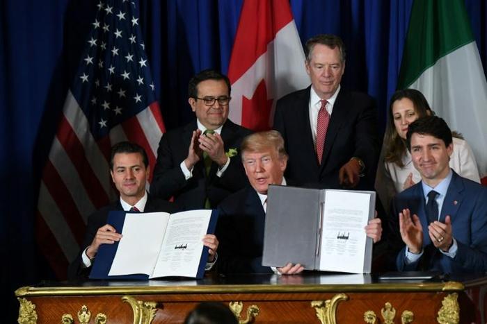 Mexico's President Enrique Pena Nieto (L) US President Donald Trump (C) and Canadian Prime Minister Justin Trudeau, are pictured in November 2018 after signing a new free trade agreement in Buenos Aires