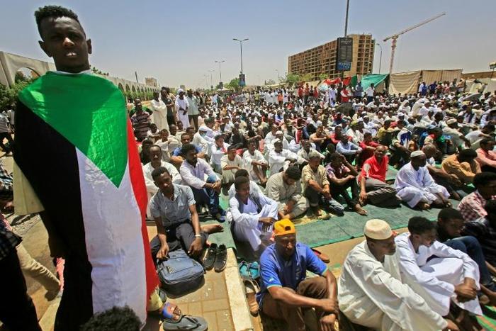 Sudanese demonstrators hold Friday prayers at the protest camp outside army headquarters in Khartoum