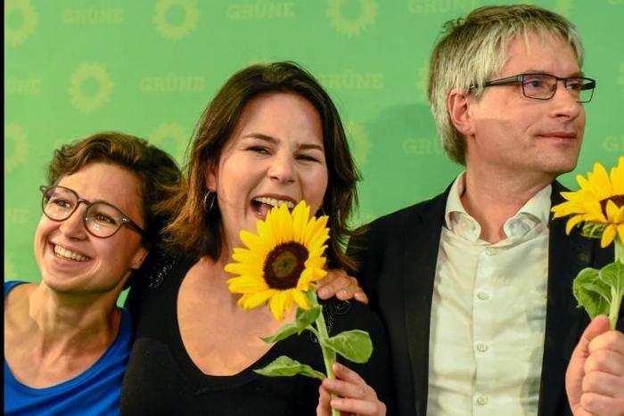 German Green party EU candidate Hannah Neumann (l) celebrates with party co-leader Annalena Baerbock and the Greens top candidate Sven Giegold after the exit poll figures were announced