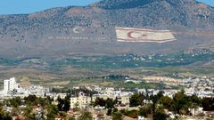 The Kyrenia mountain range, in the north of Cyprus, daubed with the Turkish flag and a quote by Turkey's late founder Ataturk, overlooks the island's divided capital of Nicosia, and can be plainly seen on the Greek Cypriot side
