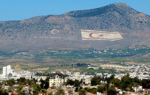 The Kyrenia mountain range, in the north of Cyprus, daubed with the Turkish flag and a quote by Turkey's late founder Ataturk, overlooks the island's divided capital of Nicosia, and can be plainly seen on the Greek Cypriot side