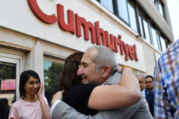 Cumhuriyet chairman Akin Atalay greets friends after being released from prison in April last year