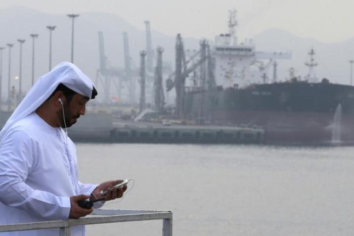 An Emirati man stands at the Fujairah oil terminal, a dock for supertankers, on September 21, 2016