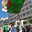 Algerians wave the national flag during a protest rally against ailing President Bouteflika's bid for a fifth term, in the capital Algiers on March 1, 2019
