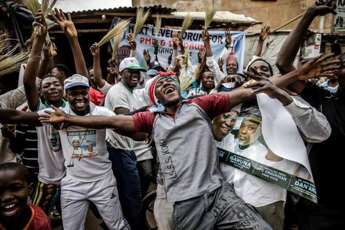Supporters of President Buhari celebrate his re-election although the reaction was generally more muted than last time