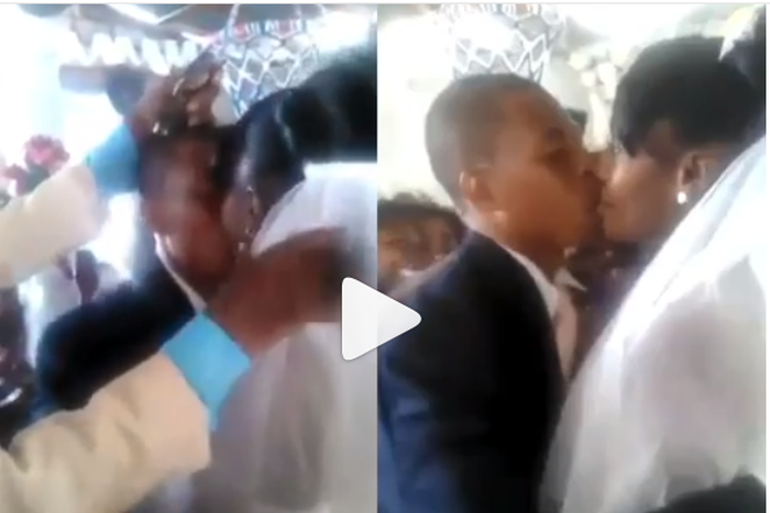 Wedding guests make unexcited groom and bride kiss by force (video)
