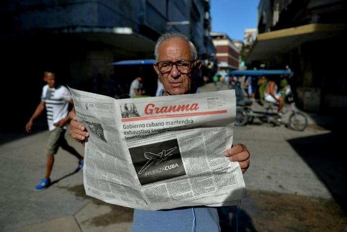 File photo of a man reading Cuban daily Granma in a Havana street, on May 19, 2018