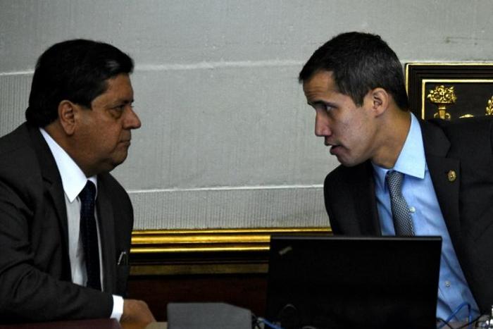 In this file photo taken on March 06, 2019, Venezuelan opposition leader and self-proclaimed acting president Juan Guaido (R) speaks with Venezuelan National Assembly's first vice-president Edgar Zambrano during a session in Caracas