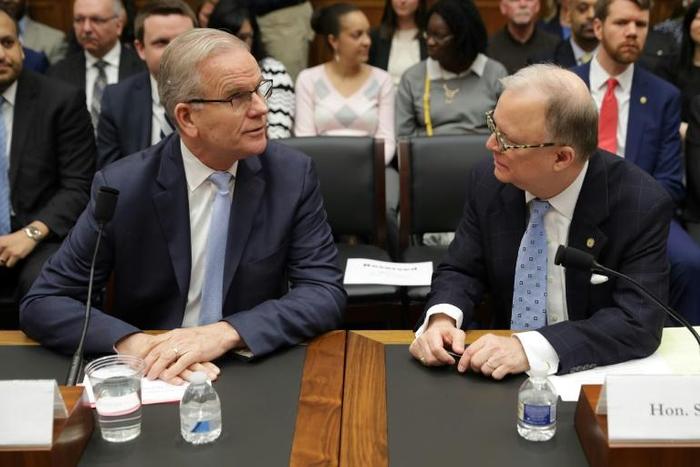 Federal Aviation Administration acting Administrator Daniel Elwell (L) and National Transportation Safety Board Chairman Robert Sumwalt talk before testifying at a House panel on the Boeing 737 MAX