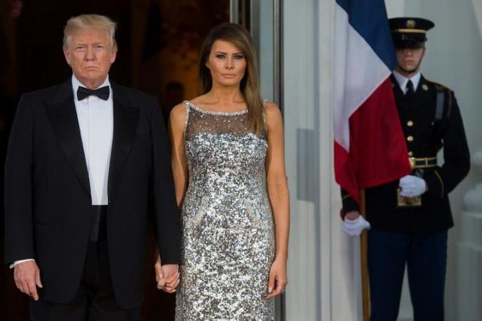 US President Donald Trump and First Lady Melania Trump, wearing Chanel couture, welcome French President Emmanuel Macron and his wife Brigitte Macron as they arrive for a State Dinner at the White House
