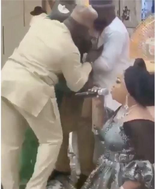 Man cries profusely as wife kneels down and showers praises on him at public event (Video)