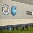 In the money: Manchester City players attend a team training session at the club's academy