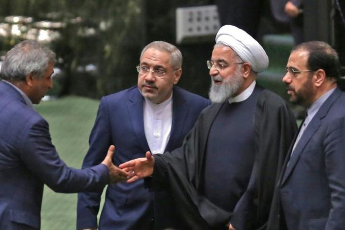Iranian lawmakers greet President Hassan Rouhani (2nd-R) in the capital Tehran on February 4, 2019.