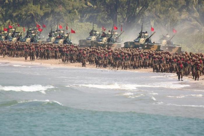 Myanmar troops and tanks move in formation along the shore during the second day of the 'Sin Phyu Shin' joint military exercises in Ayeyarwaddy delta region in 2018