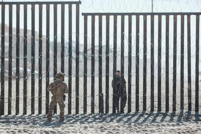 Accused of unjustified shootings: a US Border Patrol officer stands in front of the border fence that divides the US and Mexico at Friendship Park in San Diego, California