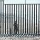 Accused of unjustified shootings: a US Border Patrol officer stands in front of the border fence that divides the US and Mexico at Friendship Park in San Diego, California