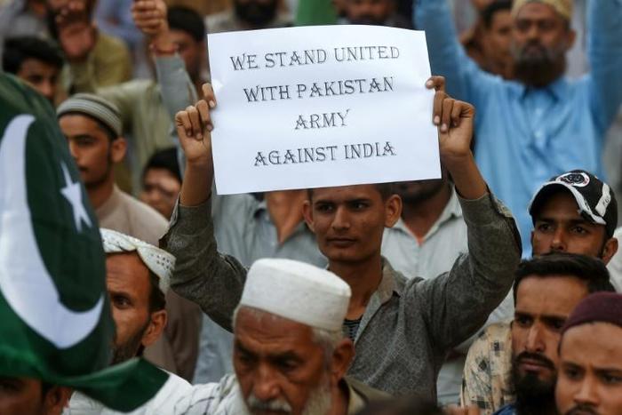 A supporter of the group Sunni Tehreek holds a placard during an anti-Indian protest in Karachi