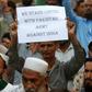 A supporter of the group Sunni Tehreek holds a placard during an anti-Indian protest in Karachi