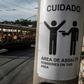 Rio's famous street car passes by a sign warning against robberies on an electricity pole in Santa Teresa, home to favelas where firefights between rival gangs and police are a common sight