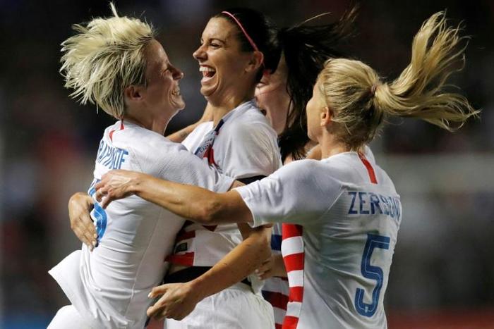 US women's soccer stars Megan Rapinoe (left) and Alex Morgan (center) are among players suing their federation for gender discrimination