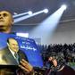 A supporter of Algeria's National Liberation Front holds up a poster of President Abdelaziz Bouteflika during a pre-campaign party rally in Algiers on February 9, 2019
