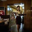 The Green Leaf Coffee Shop's 1970s-style decor is predominantly brown, and pictures of the Kimilsungia and Kimjongilia flowers named for North Korea's rulers are on show