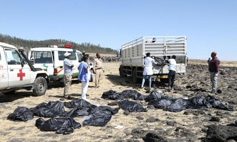 Rescue teams collect bodies at the crash site of an Ethiopia Airlines plane which came down near the capital Addis Ababa, killing all 157 on board