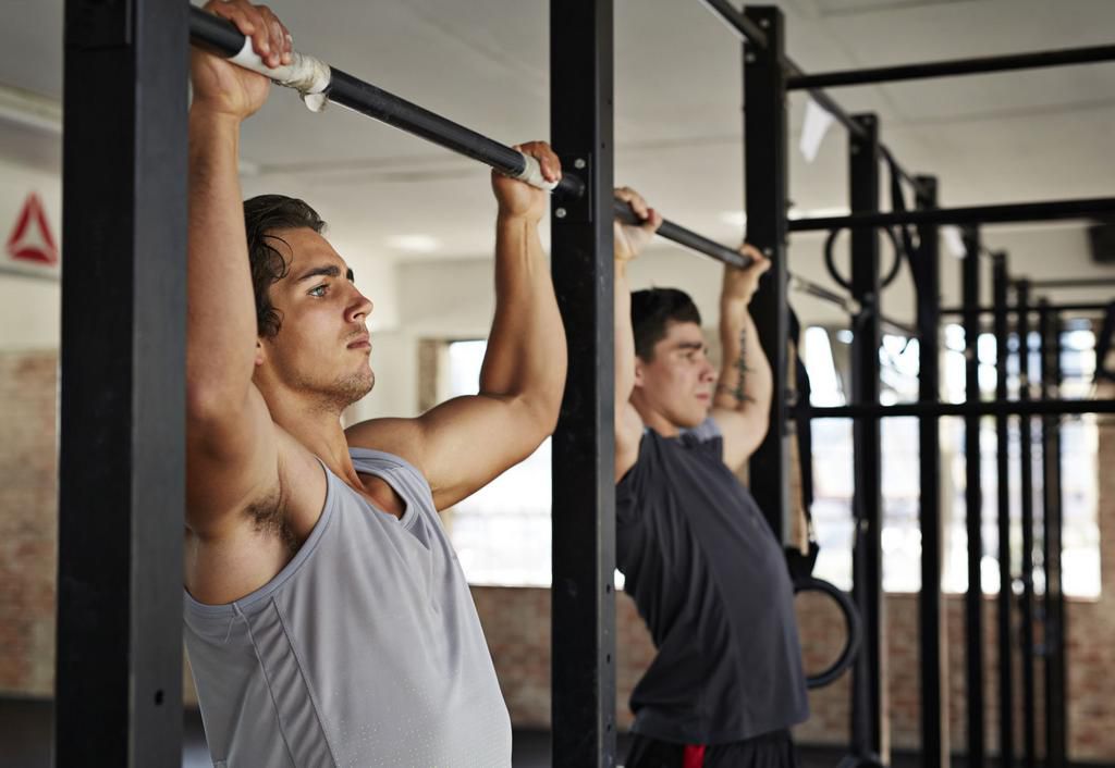 Men doing pull-up's at gym gym