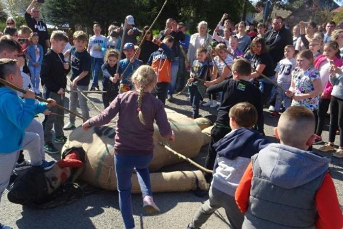 Children beat an effigy of Judas on Good Friday in the town of Pruchnik, Poland