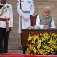 Indian Prime Minister Narendra Modi signs documents after taking the oath of office for a historic second term