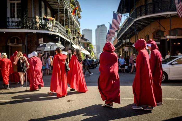 Protesters, dressed as characters in the dystopian novel and TV series "The Handmaid's Tale," march through the French Quarter of New Orleans, Louisiana, on May 25, 2019, to protest the bill to restrict abortion