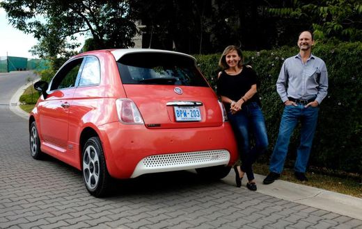 Costa Rican Erick Orlich (R) and his wife Gioconda Rojas (L) run two electric cars powered by solar panels installed on the roof of their house