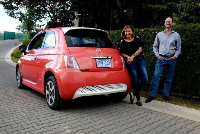 Costa Rican Erick Orlich (R) and his wife Gioconda Rojas (L) run two electric cars powered by solar panels installed on the roof of their house