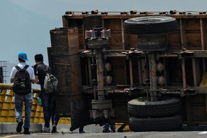 The blockaded Tienditas bridge on Venezuela's border with Colombia; President Nicolas Maduro is organizing a "Hands Off Venezuela" concert there to rival a "Venezuela Live Aid" concert being held by British billionaire Richard Branson across the border