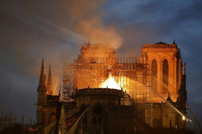 Firefighters try to douse the flames billowing the roof of Notre-Dame, a monument much loved, yet on occasion neglected, according to a top French historian