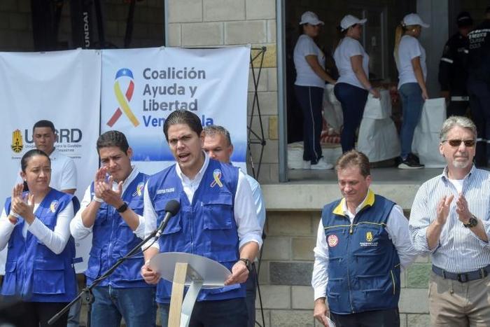 Venezuelan opposition leader Juan Guaido's envoy Lester Toledo (C) speaks to the press as US humanitarian aid arrived in Cucuta, Colombia