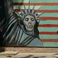 An Iranian woman walks past a mural depicting the Statue of Liberty, painted on the wall of the former US embassy in the capital Tehran on August 7, 2018