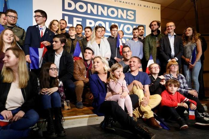 French far-right RN party leader Marine Le Pen (C) on the campaign trail vowed to appeal her case on misused EU parliament funds to the European Court of Human Rights