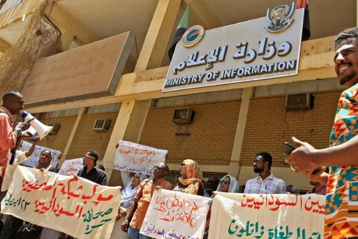 Sudanese journalists take part in a demonstration outside the information ministry