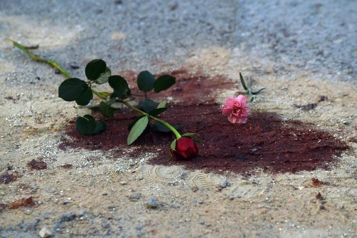 In this file photo taken on March 19, 2015, roses lie on bloodstains in front of the National Bardo Museum in Tunis after an attack the previous day that killed 21 people
