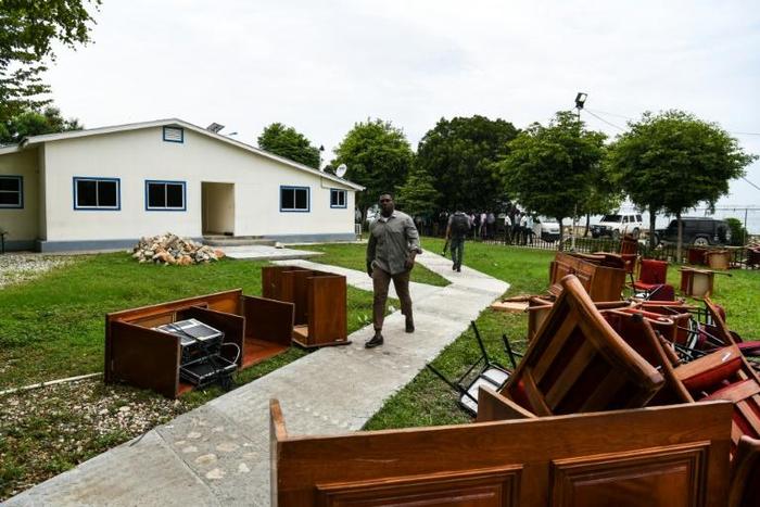 A man walks past broken tables and chairs thrown outside the Haitian Parliament in Port-au-Prince on May 30, 2019