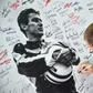 A man signs a poster of Brazilian's F1 driver Ayrton Senna during a ceremony on May 1, 2019 marking the 25th anniversary of the death of Brazilian's F1 driver Ayrton Senna during the 1994 San Marino Grand Prix