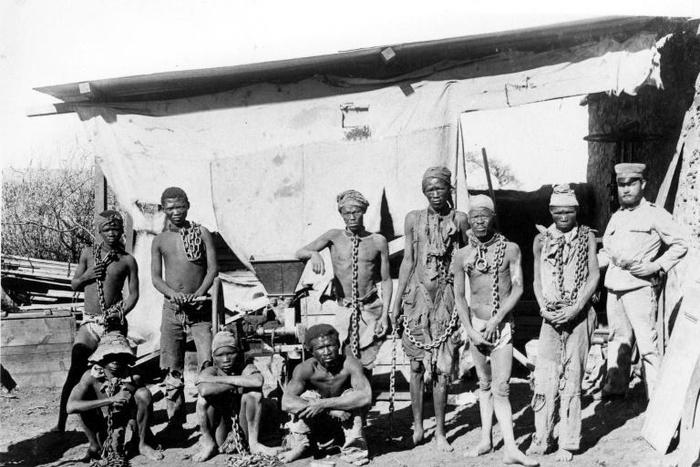 A colonial soldier (R) in German South West Africa (now Namibia) keeps a watchful eye over prisoners taken during the 1904-1908 war against the Herero and Nama people
