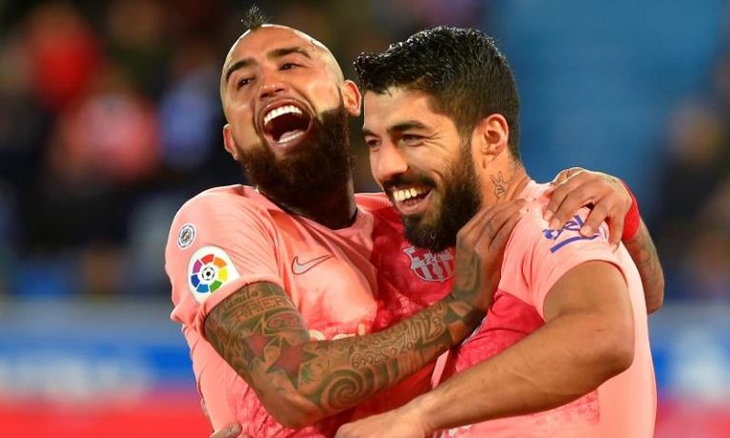 Luis Suarez (right) scored a penalty as Barcelona beat Alaves 2-0 on Tuesday in La Liga