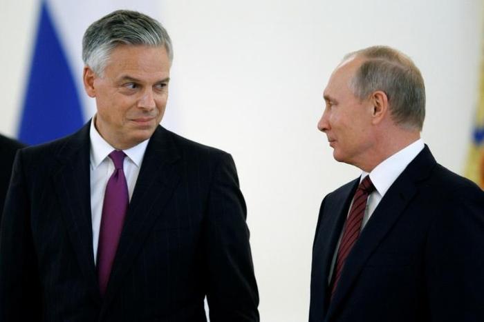 US Ambassador to Russia Jon Huntsman, pictured next to President Vladimir Putin, will not attend a major economic forum in Saint Petersburg next month