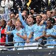 Manchester City captain Vincent Kompany lifts the FA Cup after their final rout of Watford