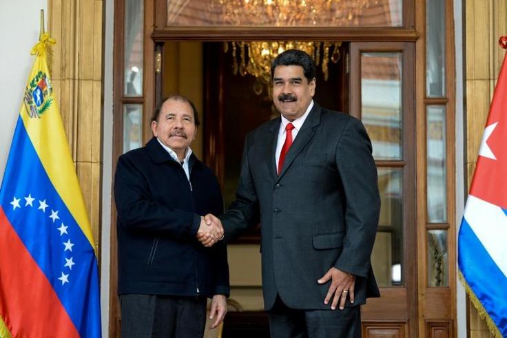 Presidents Daniel Ortega of Nicaragua and Nicolas Maduro of Venezuela shake hands during a regional meeting in Caracas in March 2018