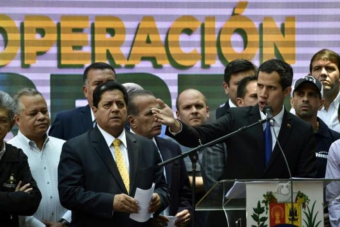 Venezuelan opposition leader Juan Guaido (right) speaks next to his deputy Edgar Zambrano, one of 10 opposition lawmakers who have been indicted for conspiracy and treason