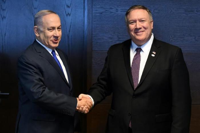 Israeli Prime Minister Benjamin Netanyahu (L) shakes hands with US Secretary of State Mike Pompeo on the sidelines of an international conference co-hosted by Washington in Warsaw and dominated by their shared hostility to Iran