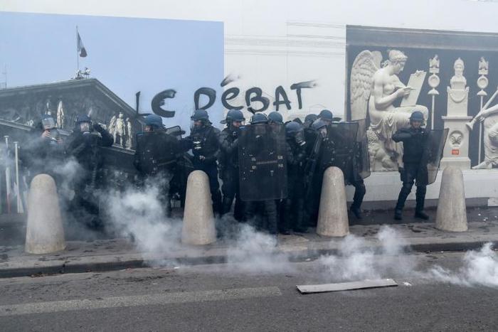 French riot police used tear gas to push back 'yellow vest' protesters outside the National Assembly building in Paris